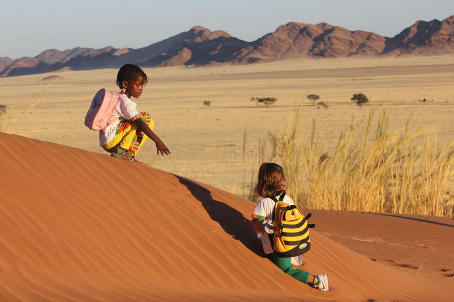 girls playing on a dune